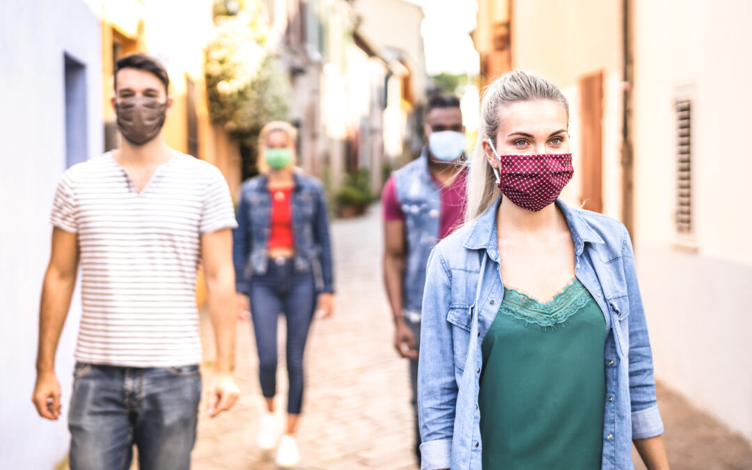 Multiracial friends walking with face mask after lockdown reopen